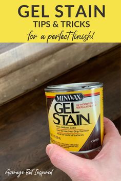 a hand holding a can of gel stain on top of a wooden table with text overlay that says gel stain tips and tricks for a perfect finish