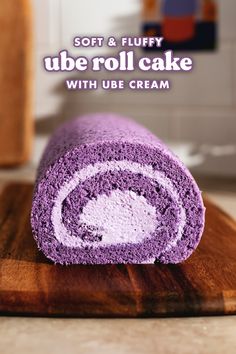 a purple roll cake sitting on top of a wooden cutting board