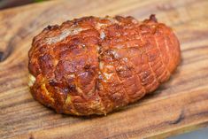 a piece of bread sitting on top of a wooden cutting board