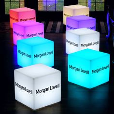 four illuminated cubes with the words morgan lovell on them