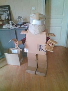 cardboard boxes are stacked on top of each other in the shape of a man's head