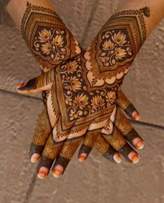 the hands are decorated with henna designs