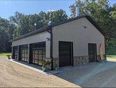 a large garage with two doors on the front and one door open to let in lots of light