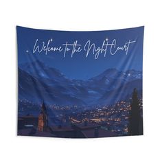 a wall hanging tapestry with the words welcome to the night court in front of snowy mountains