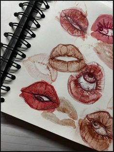 an open notebook with lipstick drawn on it