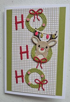 a handmade christmas card with a deer and wreath