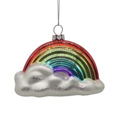 a glass ornament with a rainbow in the sky and clouds hanging from it's side