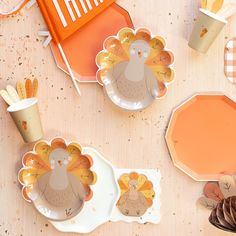 thanksgiving turkey plates and napkins on a table