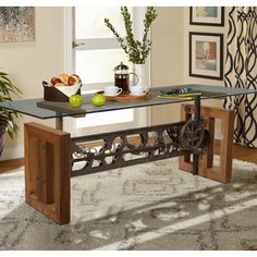 a glass table sitting on top of a rug in front of a potted plant