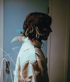 a person standing in front of a door with a knife sticking out of it's shoulder