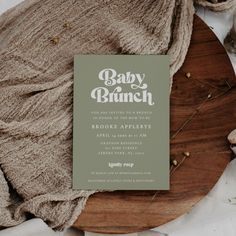 the baby brunch book is sitting on top of a wooden platter