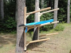 a blue surfboard propped up against a tree