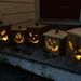 a group of pumpkins sitting in front of a house