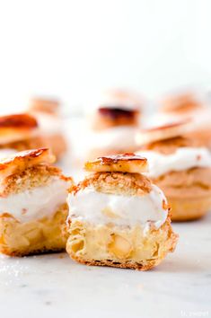 mini desserts with white frosting on them sitting on a marble counter top, ready to be eaten