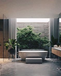 a bathroom with a large bathtub sitting in the middle of it's floor