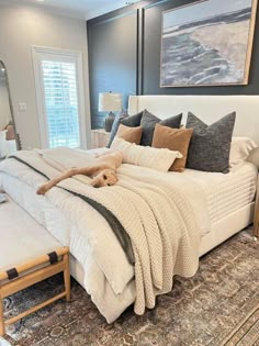 a large bed sitting in the middle of a bedroom