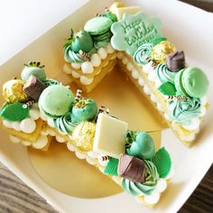 a white plate topped with green and yellow desserts