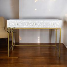 Enhance your workspace with our Floral Pattern Mother of Pearl Desk. This elegant 3-drawer desk features intricate mother of pearl inlay on a light gray finish, offering both beauty and functionality. The floral design adds a touch of luxury, while the spacious drawers provide ample storage, making it a perfect addition to your office or study. #Enhance your home office with a stylish and functional desk that adds a pop of color and elegance. #Organize your study essentials with the three spacio Study Essentials, Functional Desk, White Desks, Bone Inlay, Office Furniture Desk, Desk With Drawers, Office Furniture, Living Area, Living Furniture