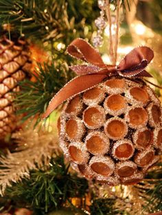 a pine cone ornament hanging from a christmas tree with cinnamons on it