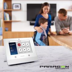 an alarm clock sitting on top of a counter next to a family in the kitchen