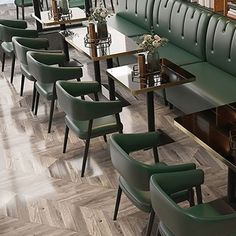 a restaurant with green leather booths and wooden tables