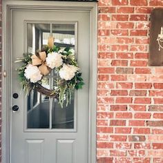 a gray front door with a wreath on it