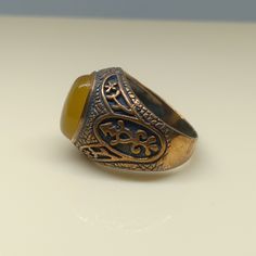 This empower ring is an awesome design bronze ring with an oval yellow Aqeeq. It is an awesome Masonic icon design bronze ring with a cabochon Yellow Aqeeq. It is an awesome design bronze ring. It has designed and made in Thailand. It is for the people who love to collect rare limited edition items and who wants to be different. This ring is one of a kind item for you. Material: Bronze The Main Stone: Yellow Aqeeq (Yellow Agate) Stone Color: Yellow Stone size: 10 x 14 mm. Ring weight approx.: 8 Bronze Oval Rings As Gifts, Bronze Oval Rings For Gift, Oval Bronze Rings For Gift, Vintage Bronze Signet Ring Gift, Vintage Bronze Signet Ring For Gift, Vintage Brown Signet Ring As A Gift, Handmade Brown Signet Ring As Gift, Handmade Brown Signet Ring For Gift, Yellow Agate