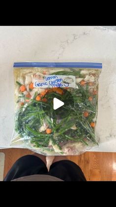 someone is standing in front of a bag of vegetables