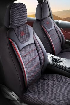 the interior of a car with grey leather and red stitching on the front seats