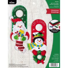 two christmas door hangers with santa and snowman decorations on the front, one is red