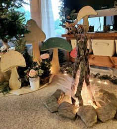 a group of mushrooms sitting on top of a floor next to rocks and potted plants