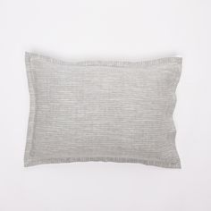 a gray pillow on a white background