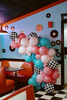 the balloon arch is decorated with checkered balloons