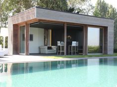 a pool house with an outdoor dining area next to it