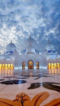 the grand mosque in abura is lit up at night