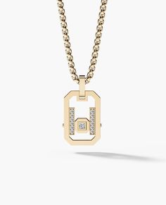 a gold necklace with diamonds on the bottom and a small square pendant hanging from it