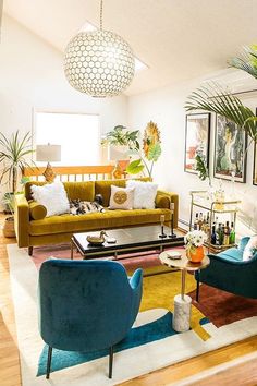 a living room filled with furniture and lots of plants on top of the tables in front of them