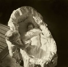 an old photo of two children sleeping in a bed