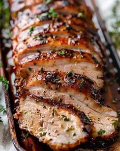 sliced pork loin with herbs on the side