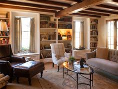 a living room filled with furniture and bookshelves