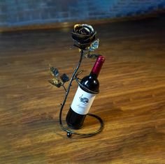 a wine bottle holder with a rose on it