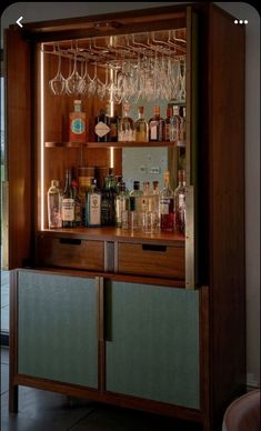 a bar with wine glasses and liquor bottles