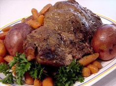 a white plate topped with meat, potatoes and carrots