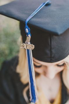 a young woman wearing a graduation cap and tassel with a cross on it's end