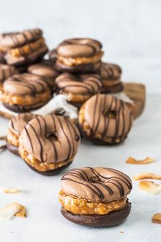 chocolate covered doughnuts with peanut butter frosting on top and more donuts in the background