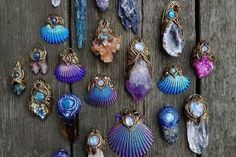 many different types of jewelry on a wooden surface with beads and stones around them,