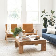 a living room with two couches and a coffee table in front of the window