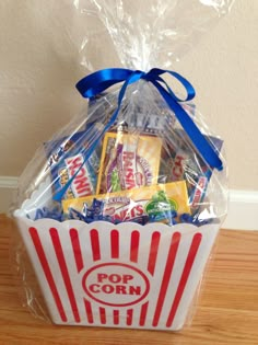 a popcorn bag filled with snacks on top of a wooden table