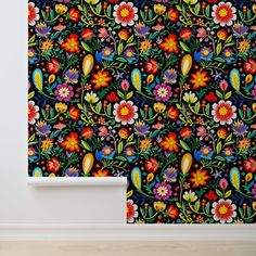 an artistic wallpaper with colorful flowers and leaves on it's side, against a white wall