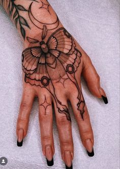 a woman's hand with tattoos on it